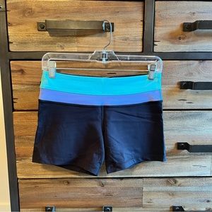 Lululemon Reverse Groove Short. Size 6 in black with purple and aqua waistband.
